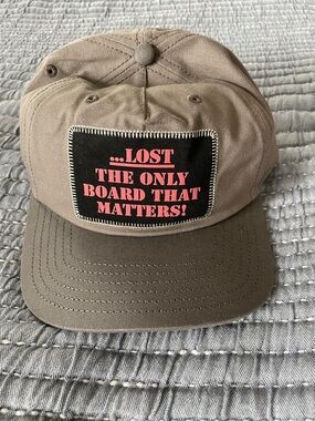 Lost Tan Baseball Cap with Black Patch and Pink Lettering